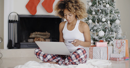 Image showing Young woman shopping online for Christmas