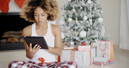 Image showing Young woman attending to Xmas social media
