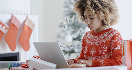 Image showing Trendy young woman working on a laptop