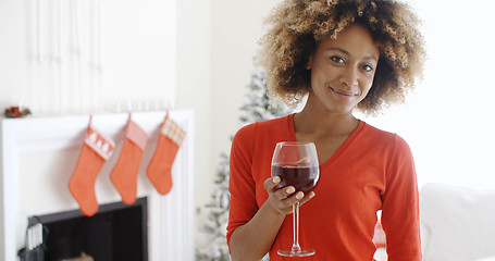 Image showing Young woman offering a Christmas toast