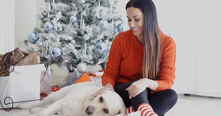 Image showing Laughing young woman with her dog at Christmas