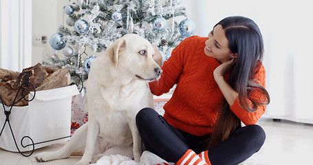 Image showing Young woman and her dog celebrating Christmas