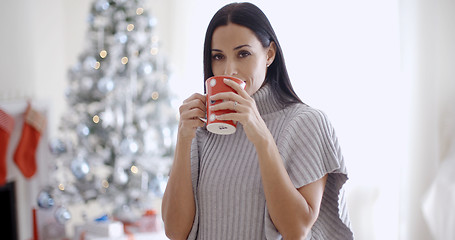 Image showing Woman enjoying a cup of Christmas coffee