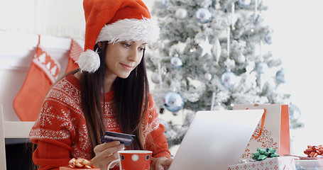 Image showing Young woman ordering Christmas gifts online