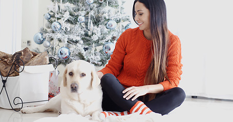 Image showing Young woman and her dog celebrating Christmas