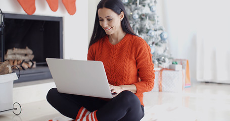 Image showing Young woman relaxing at home over Christmas