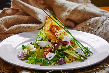 Image showing Fresh spring salad with feta cheese, red onion in white bowl. 