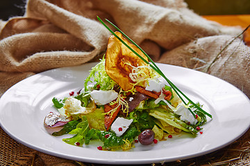 Image showing Fresh spring salad with feta cheese, red onion in white bowl. 