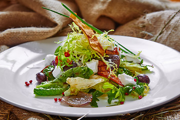 Image showing Fresh spring salad with feta cheese, red onion in white bowl. 