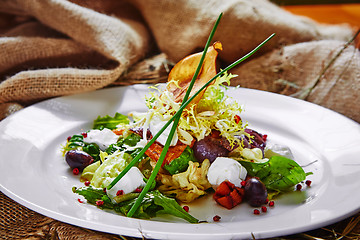 Image showing Fresh spring salad with feta cheese, red onion in white bowl. 