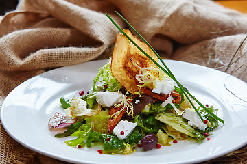 Image showing Fresh spring salad with feta cheese, red onion in white bowl. 