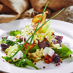 Image showing Fresh spring salad with feta cheese, red onion in white bowl. 