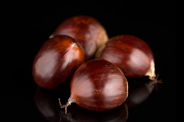 Image showing Chestnuts on a black reflective background