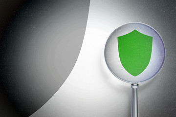 Image showing Security concept:  Shield with optical glass on digital background