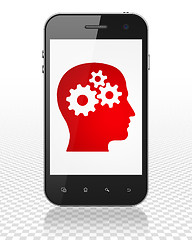 Image showing Marketing concept: Smartphone with Head With Gears on display
