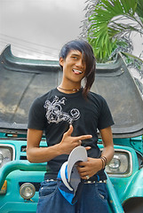 Image showing Asian emo teenager in front of macho car