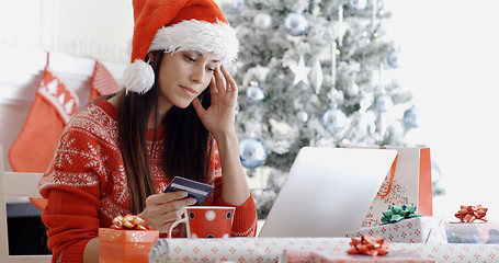 Image showing Young woman ordering Christmas gifts online