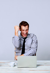 Image showing Happy man working on laptop in the office