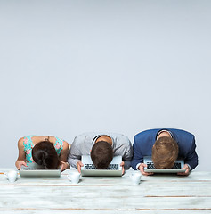 Image showing Business team working together at office and sleeping on gray background