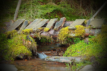 Image showing wooden old bridge on mountain stream