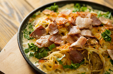 Image showing home made casserole on the wooden table