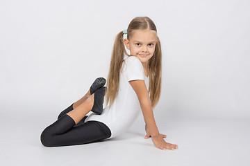 Image showing Girl gymnast performs an exercise fish