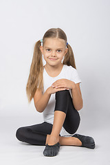 Image showing Girl gymnast sitting on the floor