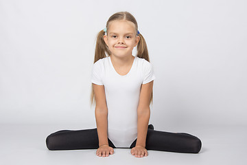 Image showing Girl gymnast performs exercises Frog