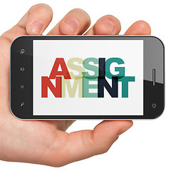 Image showing Law concept: Hand Holding Smartphone with Assignment on  display