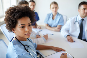 Image showing female doctor over group of medics at hospital