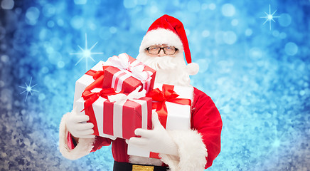 Image showing man in costume of santa claus with gift boxes