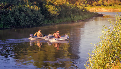 Image showing Fishermen on the river float boat