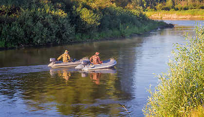 Image showing Fishermen on the river float boat