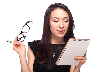 Image showing Young office worker in glasses with notebook