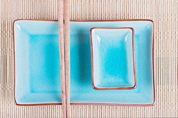 Image showing Top view to bamboo mat, dish and chopsticks