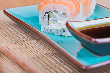 Image showing California maki sushi with fish on azul plate