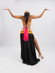 Image showing Young girl mulatto dancing in a long black dress candid