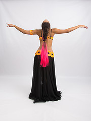 Image showing Young girl mulatto dancing in a long black dress candid