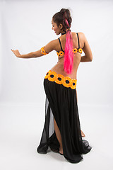 Image showing Young girl mulatto dancing in a long black dress candid