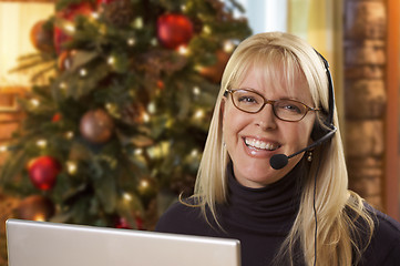 Image showing Woman with Phone Headset In Front of Christmas Tree, Computer