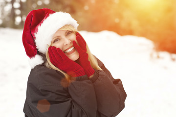 Image showing Attractive Santa Hat Wearing Blond Woman Having Fun in Snow