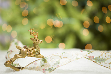 Image showing Christmas Reindeer Ornament, Ribbon on Snow with Tree and Lights