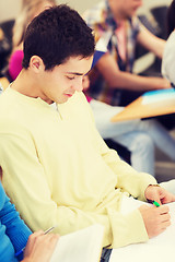 Image showing group of smiling students with notebooks