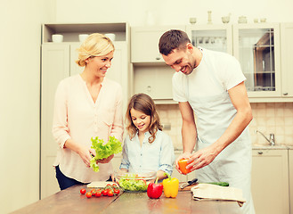 Image showing happy family making dinner in kitchen