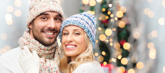 Image showing smiling couple in winter clothes hugging