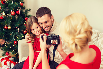 Image showing mother taking picture of father and daughter