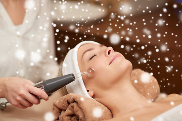 Image showing close up of young woman having face massage in spa