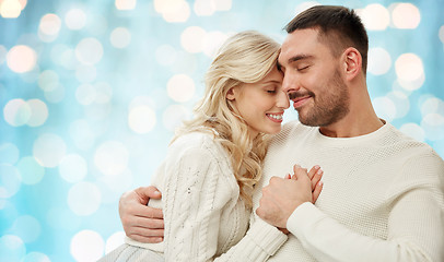 Image showing happy couple over blue holidays lights background
