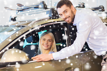 Image showing happy couple buying car in auto show or salon