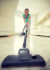 Image showing happy woman with vacuum cleaner at home